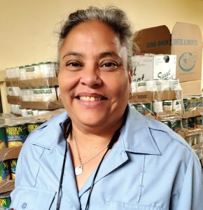 Nohelia came to the pantry during thepandemic and now volunteers packing boxes and translating when needed.