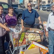 Group of people with shopping cart full of food